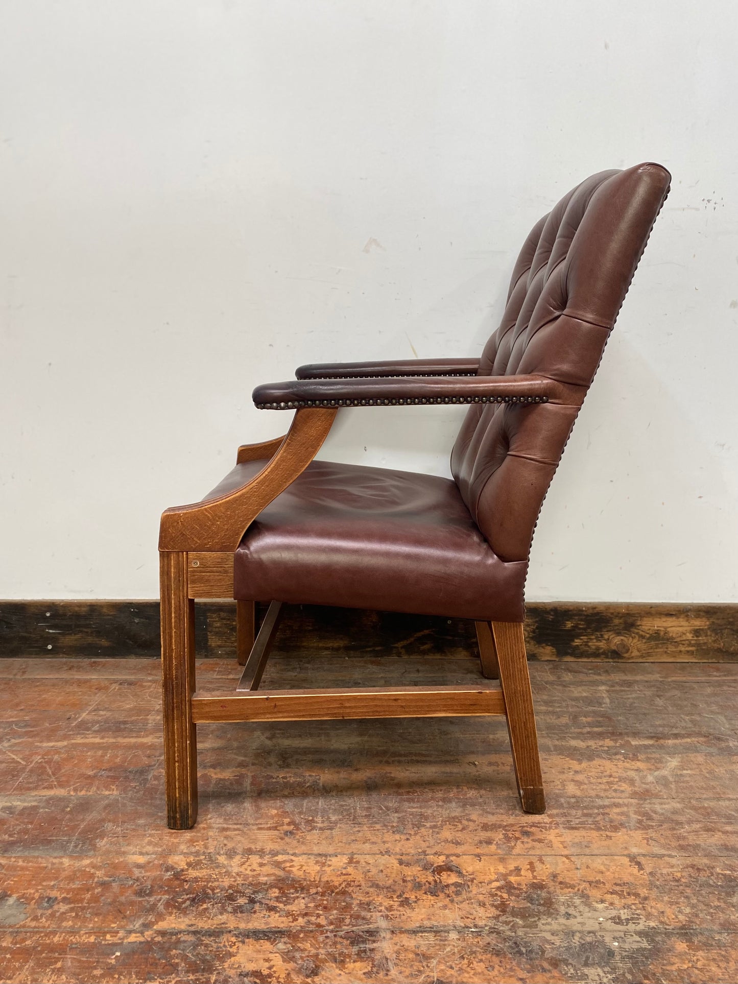 Brown leather armchair with wood frame