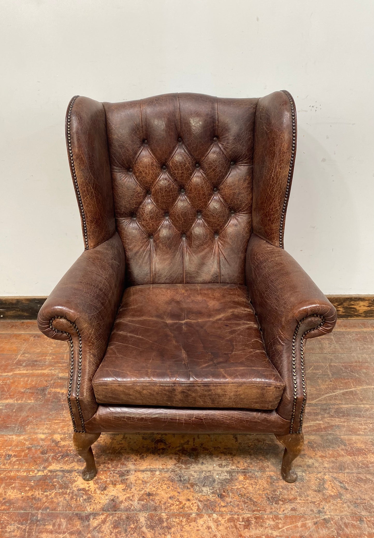 Wingback armchair in brown leather