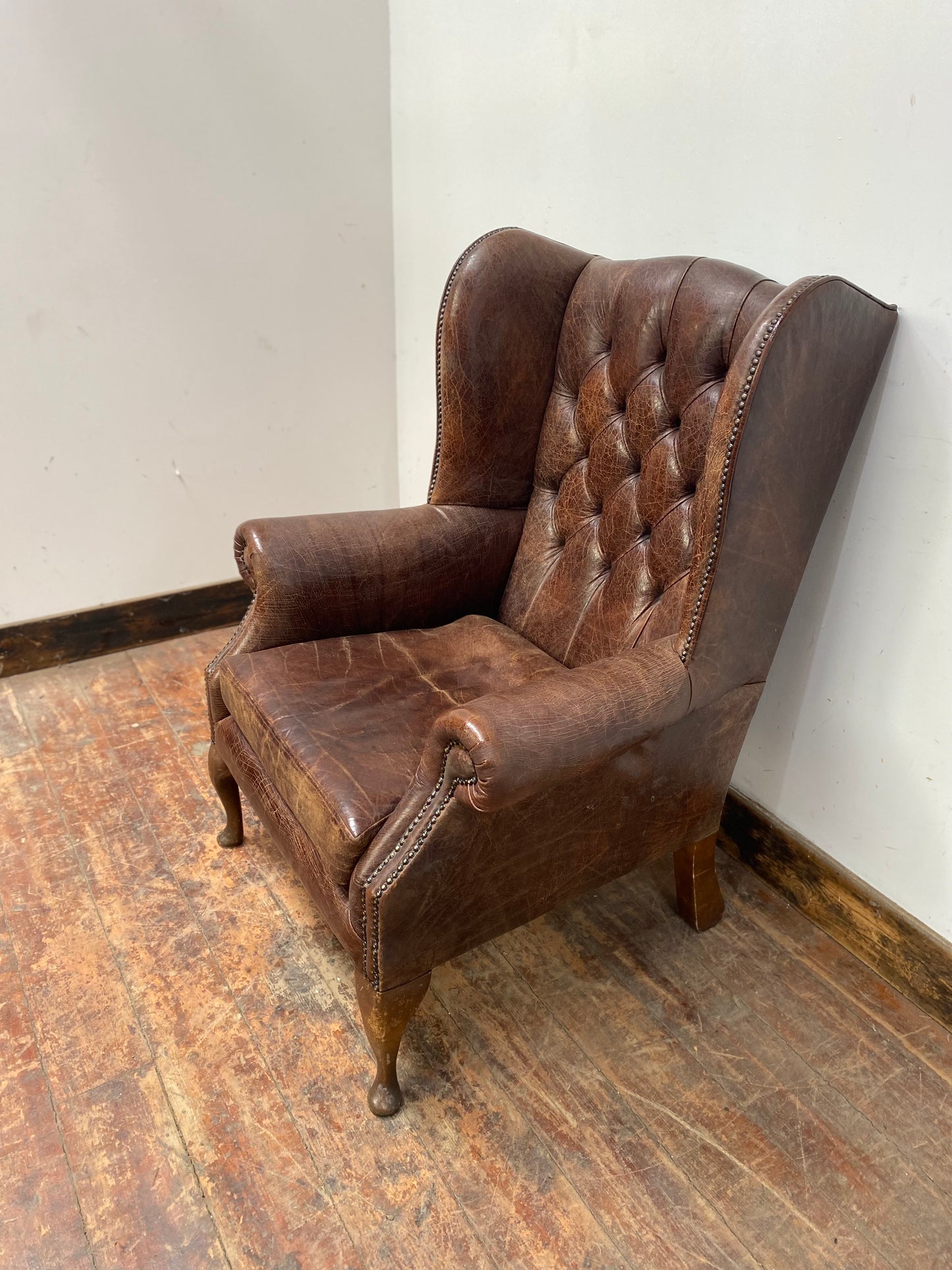 Wingback armchair in brown leather