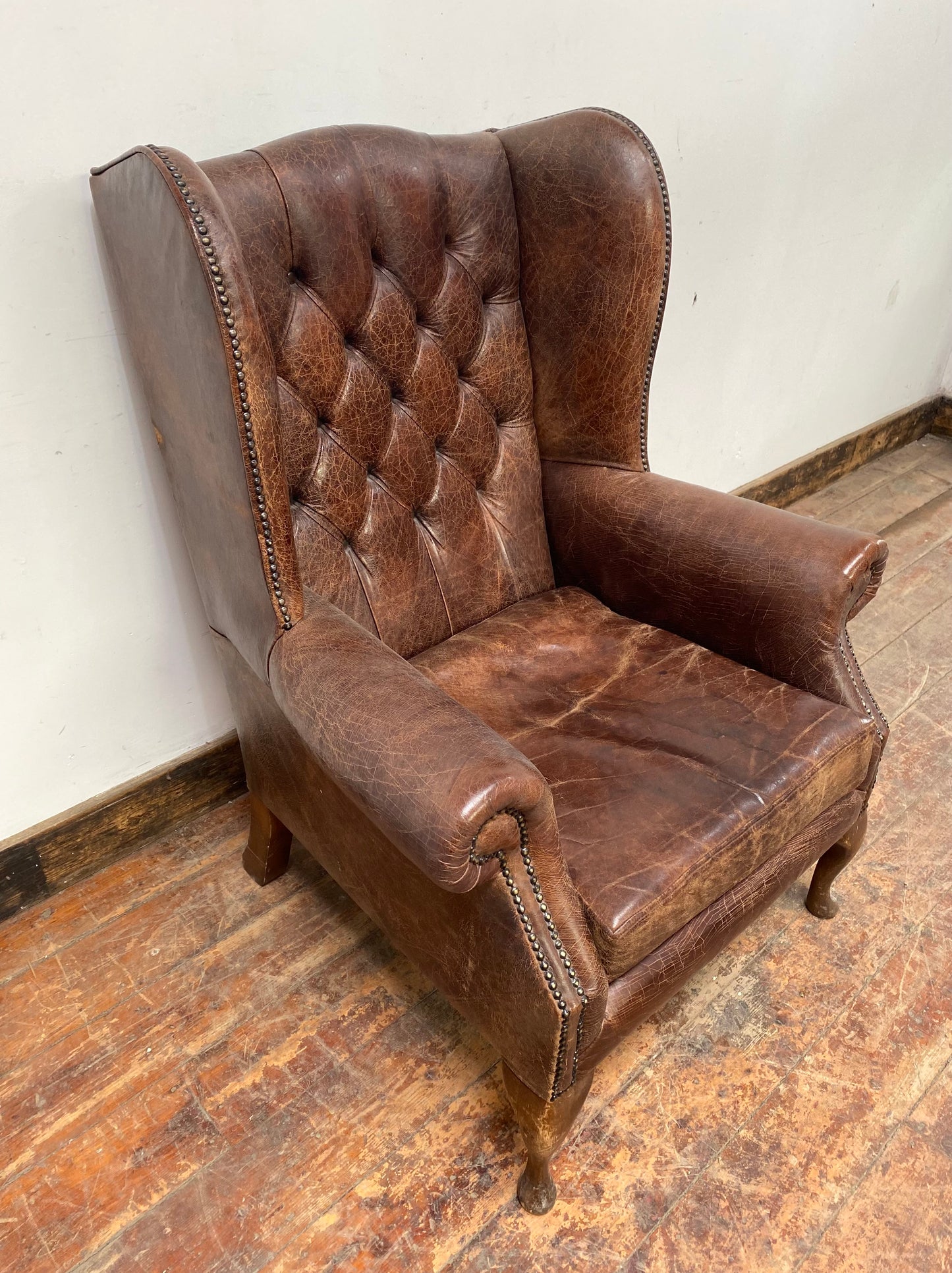 Wingback armchair in brown leather