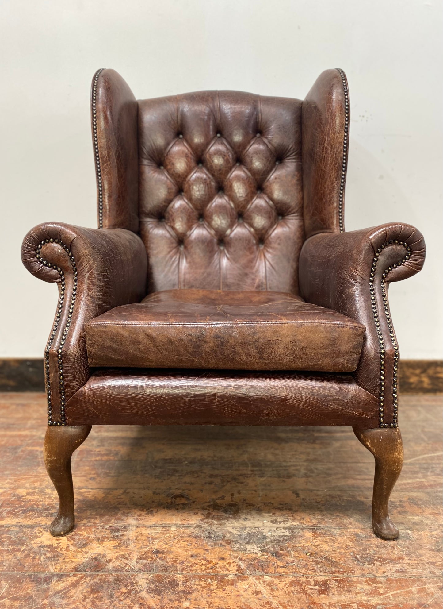 Wingback armchair in brown leather