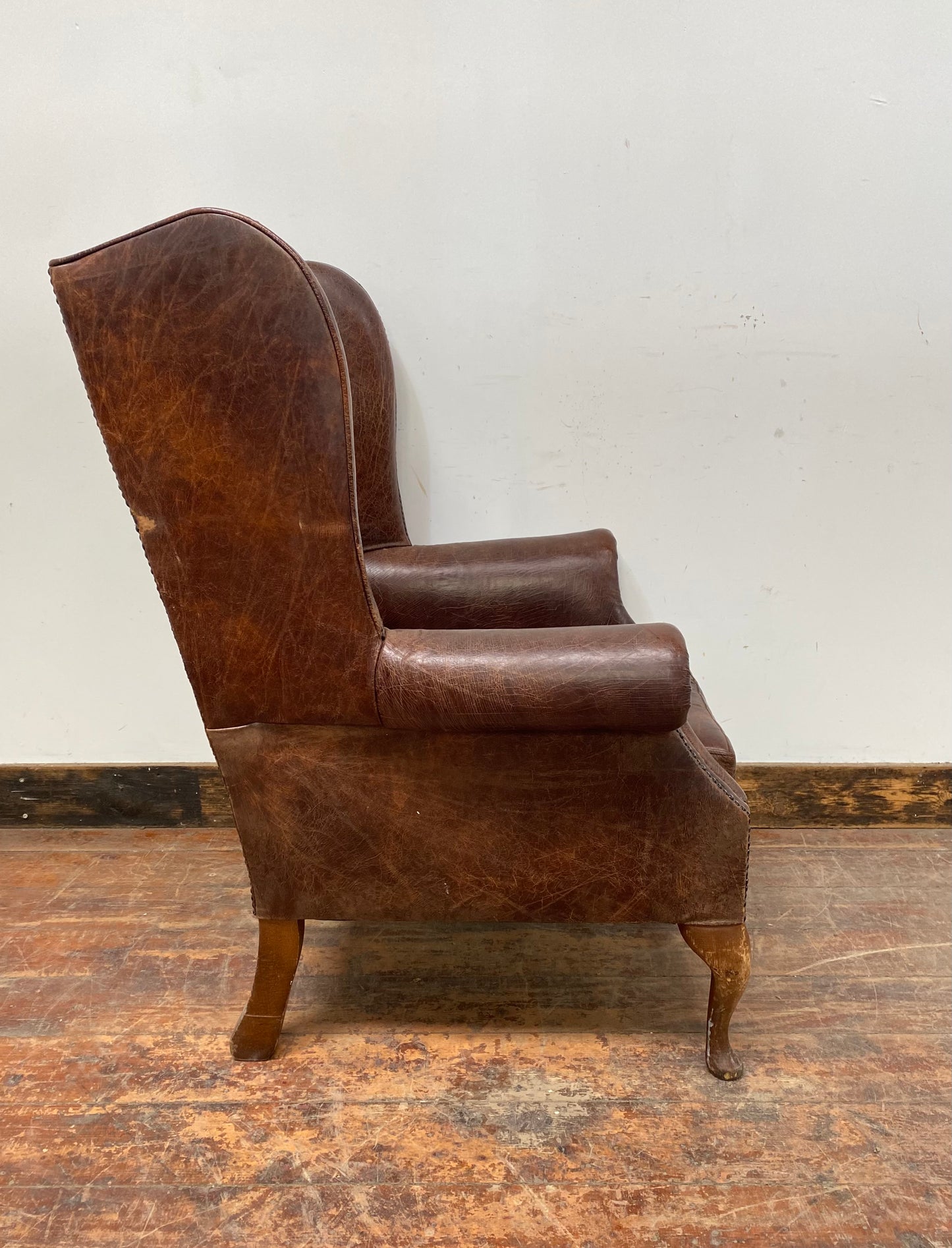 Wingback armchair in brown leather