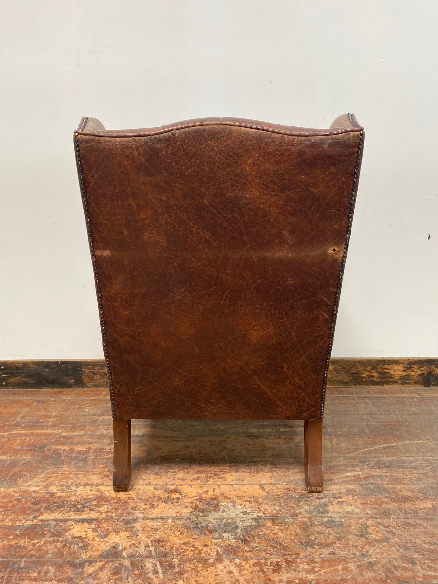 Wingback armchair in brown leather