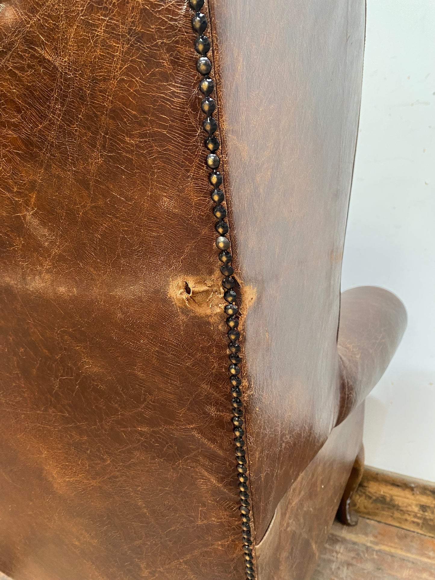 Wingback armchair in brown leather