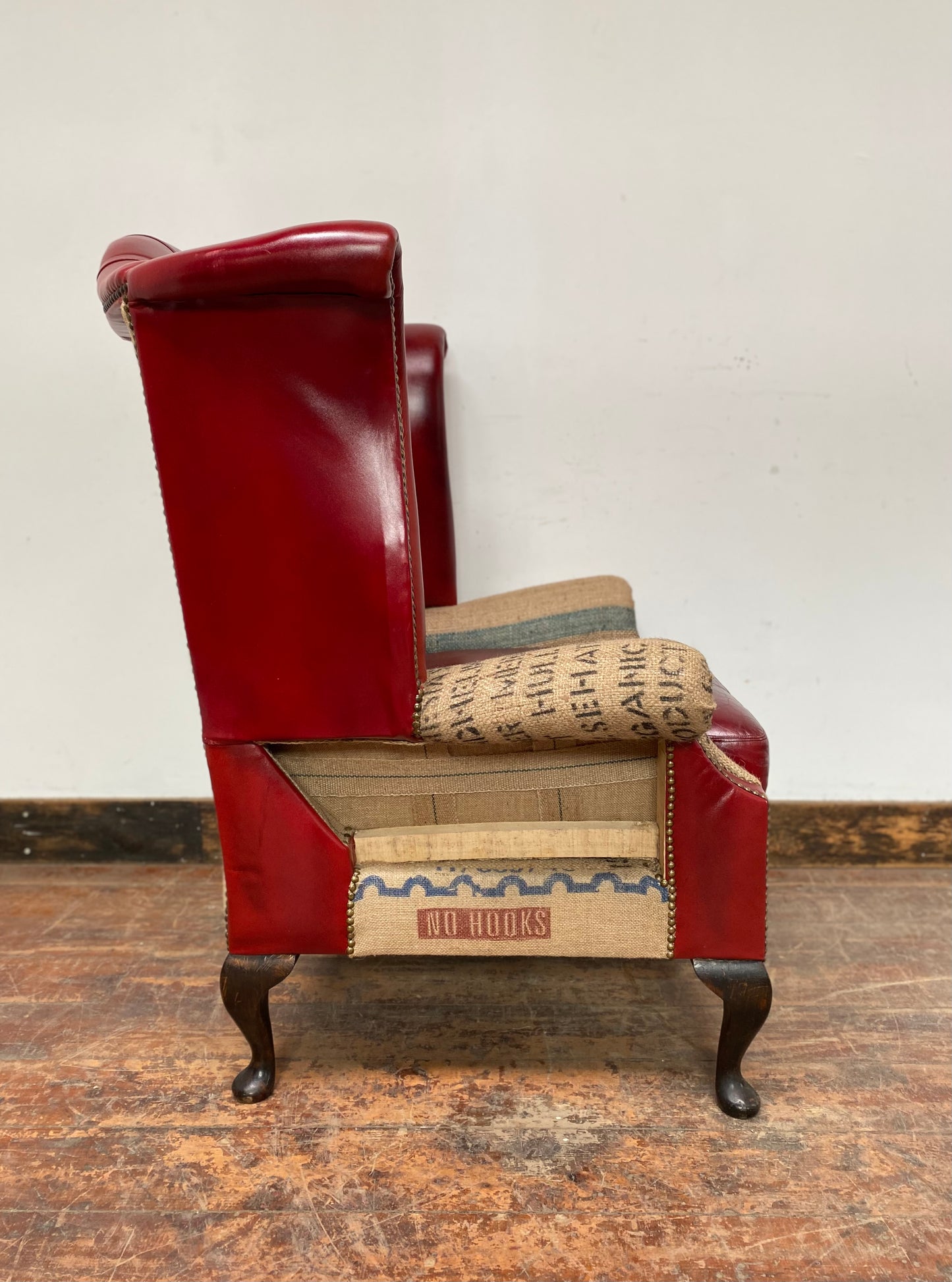 Deconstructed wingback armchair in red leather