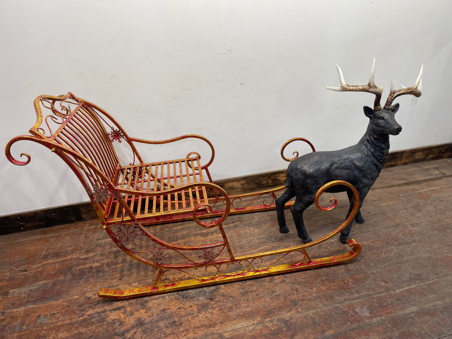 Red and gold Christmas sleigh including reindeer figure