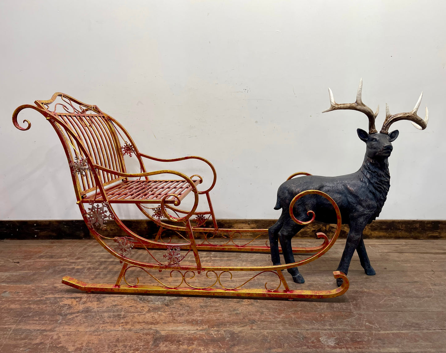 Large red and gold metal Christmas sleigh