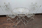 Metal Domed Patio Table and Two Chairs with Weathered Ornate Fence Design