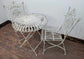 Metal Domed Patio Table and Two Chairs with Weathered Ornate Fence Design