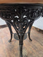 Medium Round Dining Table with Ornate Cast Iron Base and Light Wood Top
