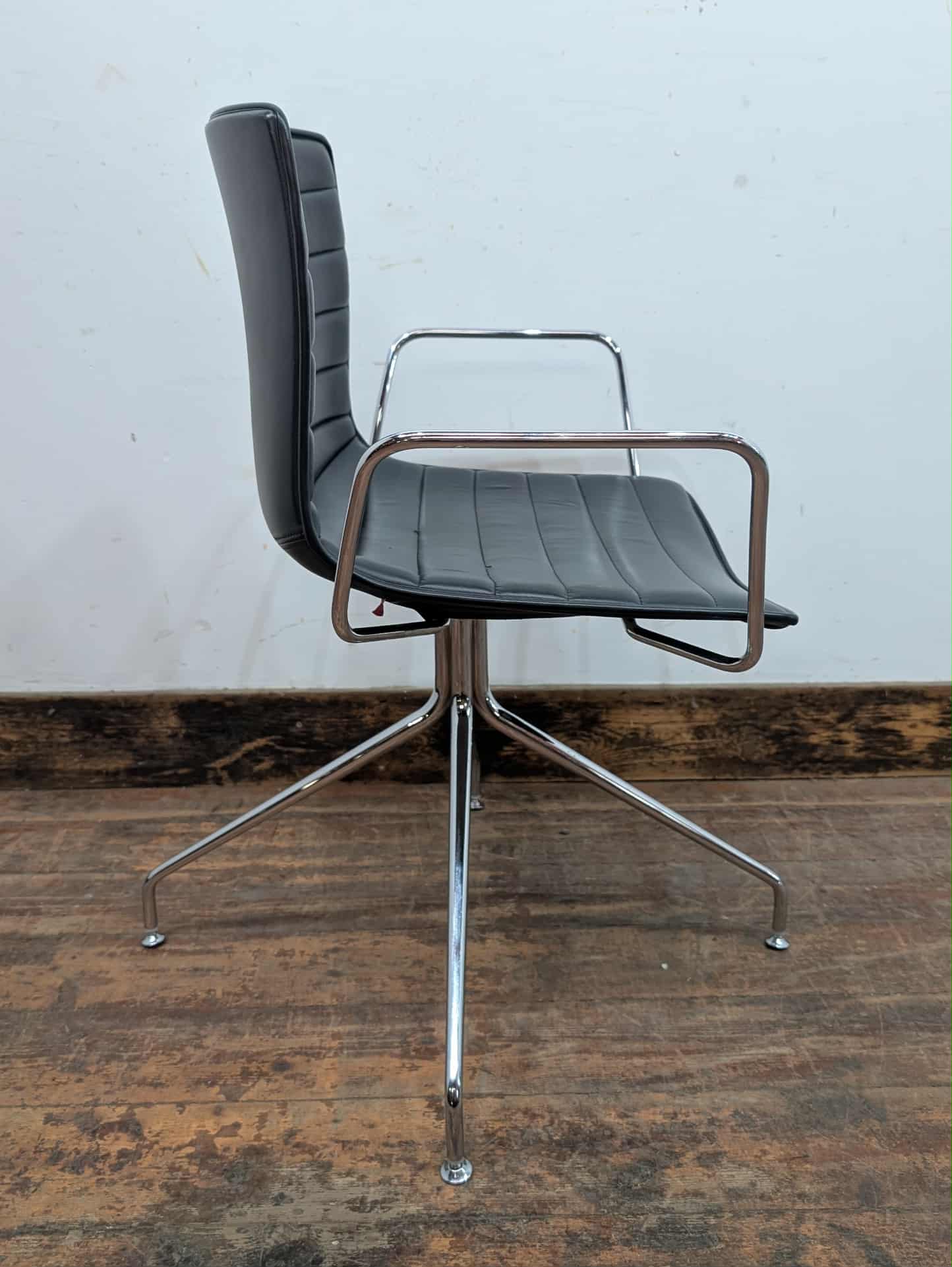 Set of 11 black faux leather swivel chairs with chrome frames