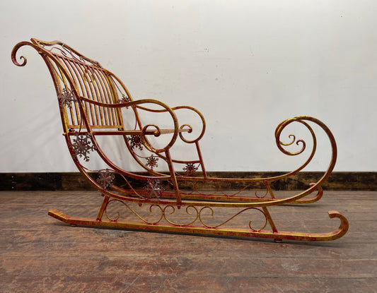 Large red and gold metal Christmas sleigh