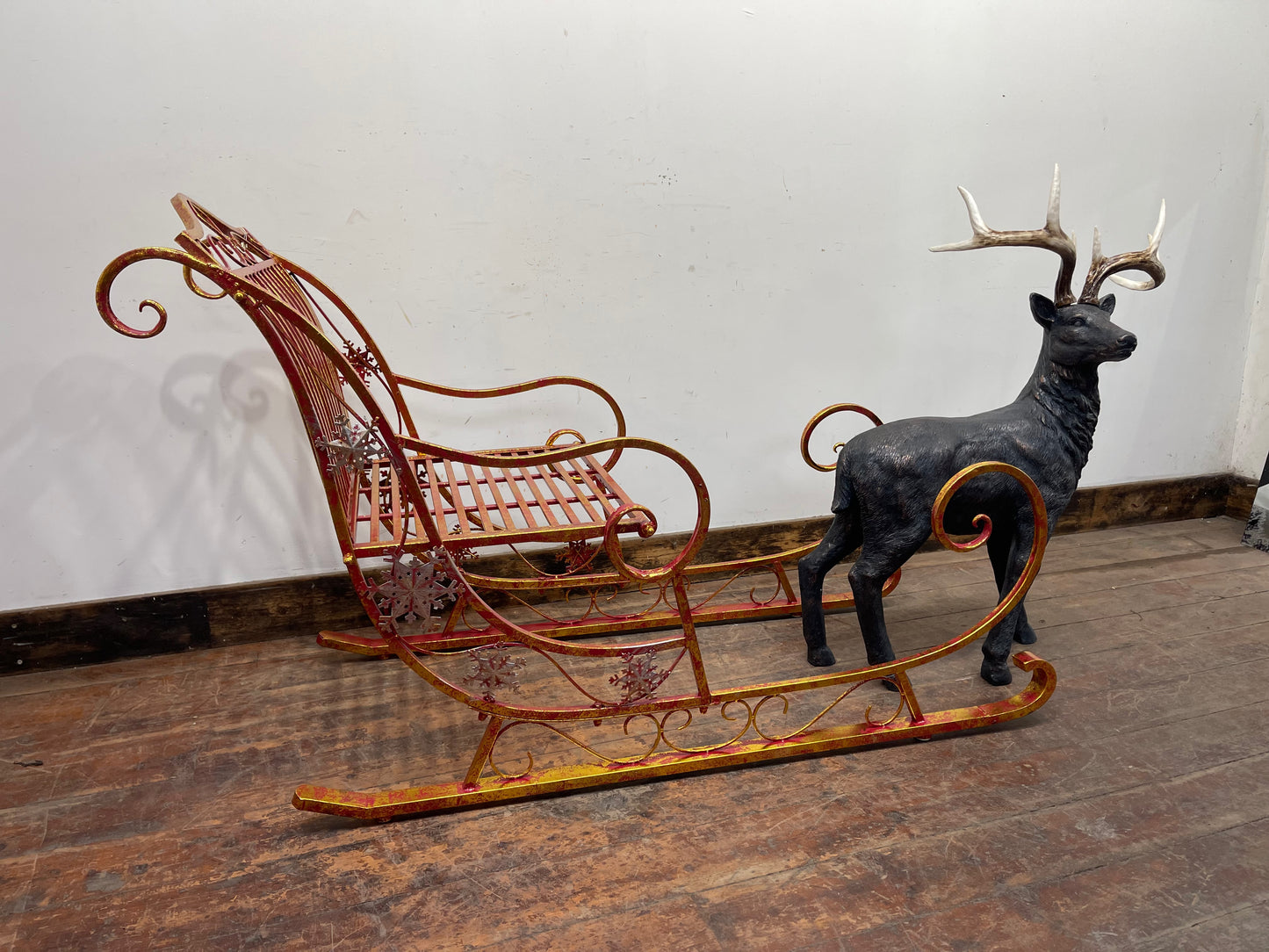 Red and gold Christmas sleigh including reindeer figure