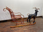 Red and gold Christmas sleigh including reindeer figure