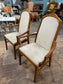 Pair of dining chairs with armrests and light fabric upholstery
