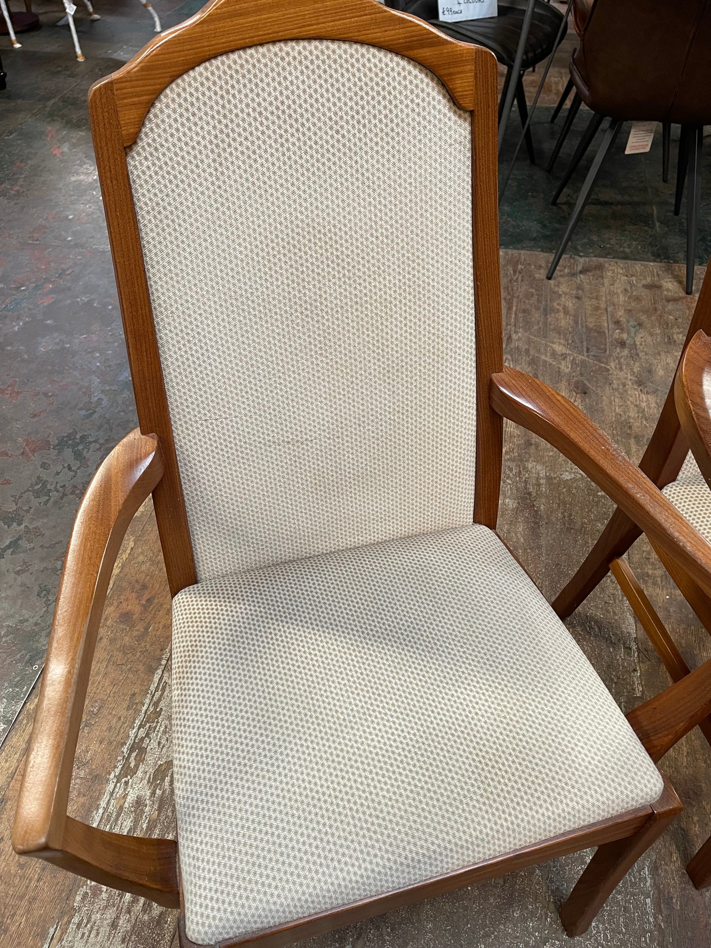 Pair of dining chairs with armrests and light fabric upholstery