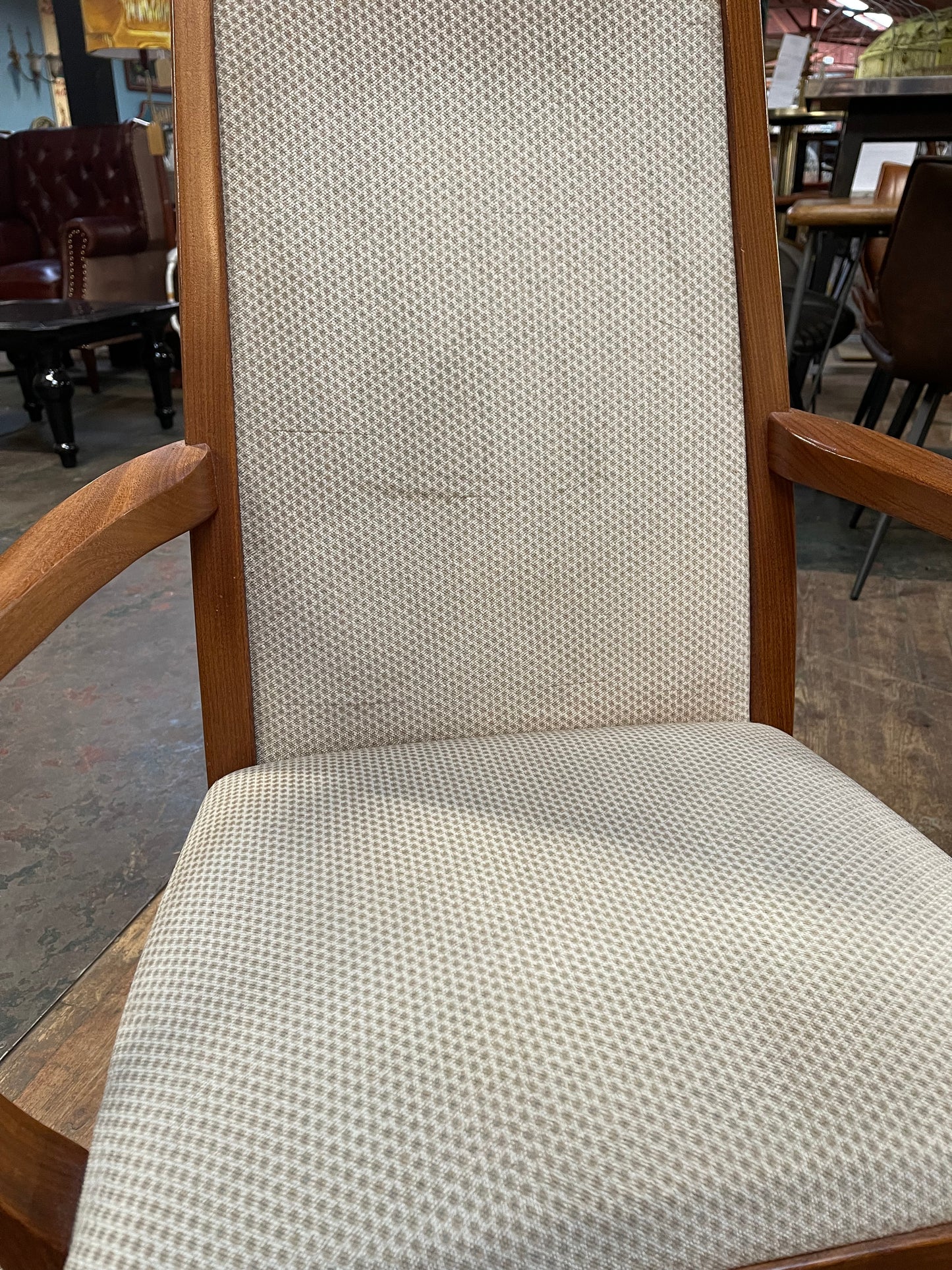 Pair of dining chairs with armrests and light fabric upholstery