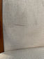 Pair of dining chairs with armrests and light fabric upholstery