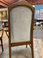 Pair of dining chairs with armrests and light fabric upholstery