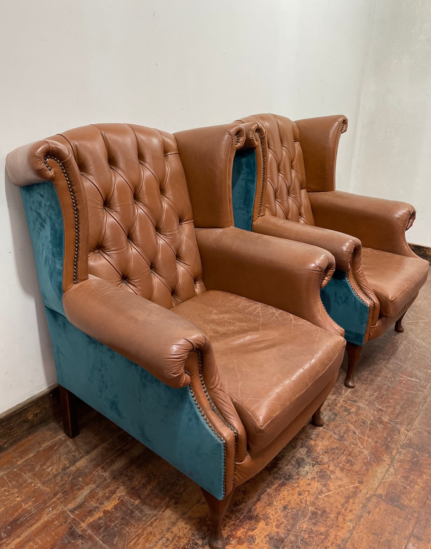 Pair of tan leather wingbacks with bright blue back and sides