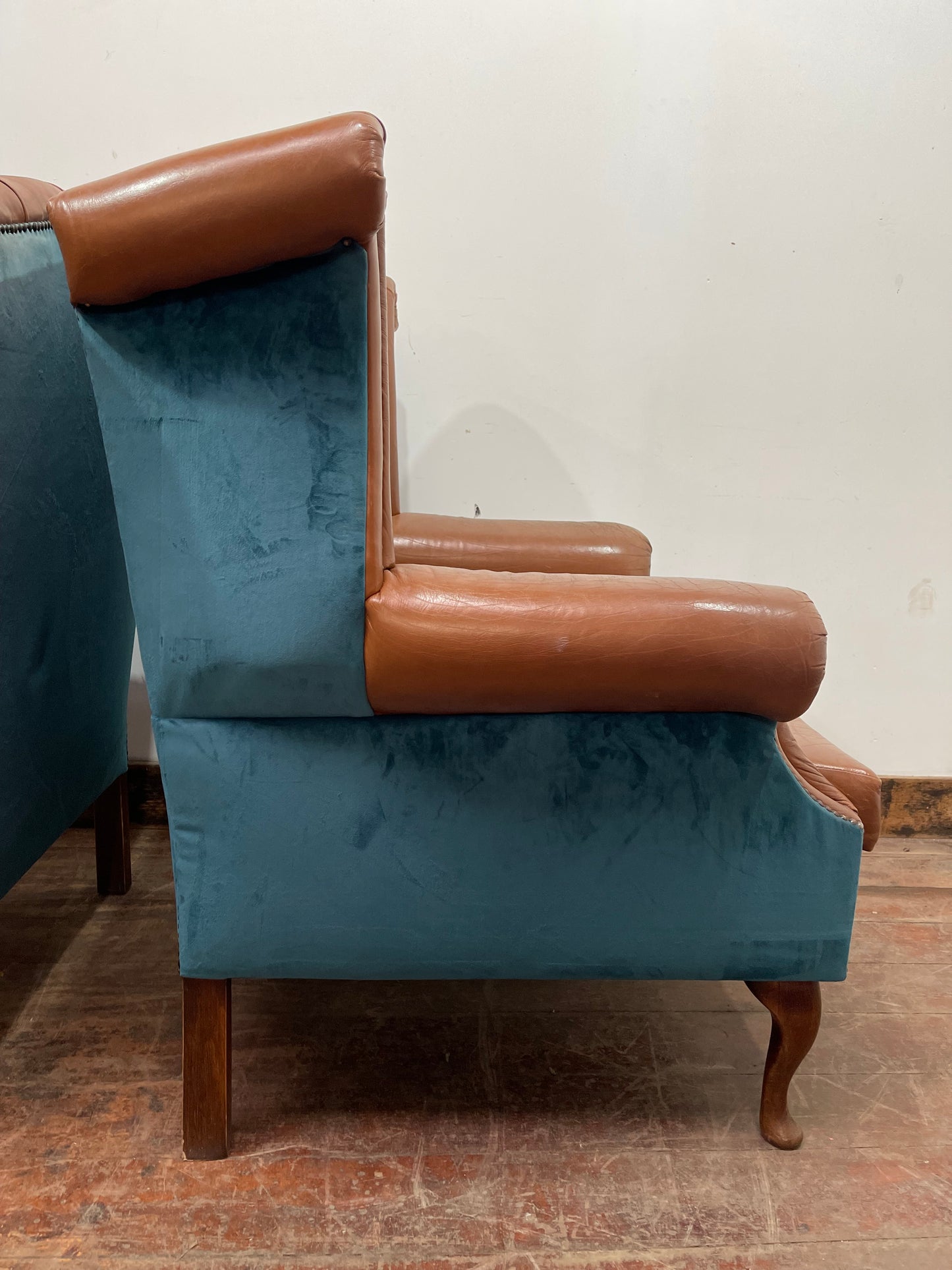 Pair of tan leather wingbacks with bright blue back and sides