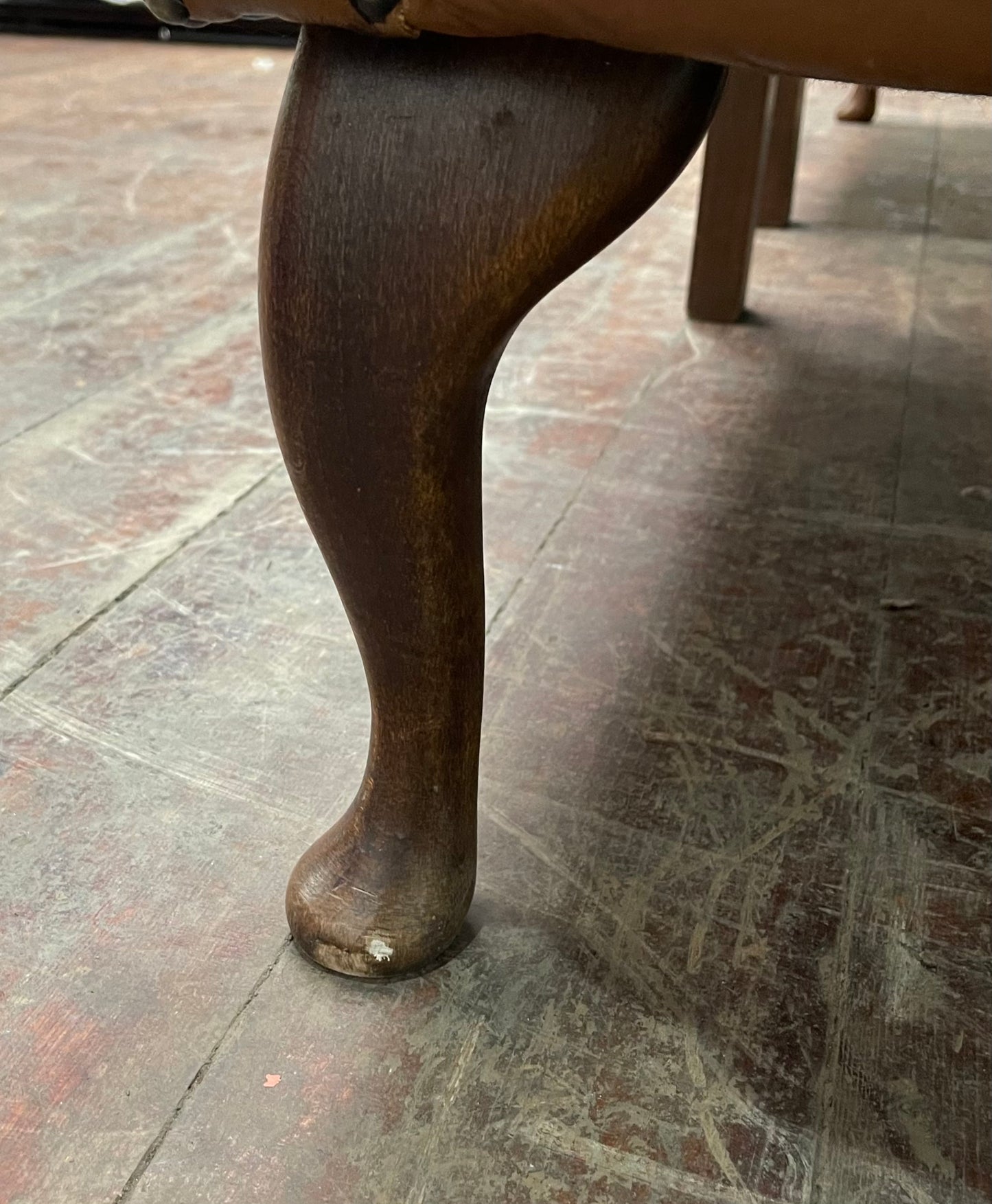 Pair of tan leather wingbacks with bright blue back and sides
