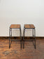 Industrial style bar stools with tilted seats