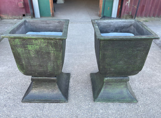 Matching pair of large outdoor urns in dark green colour