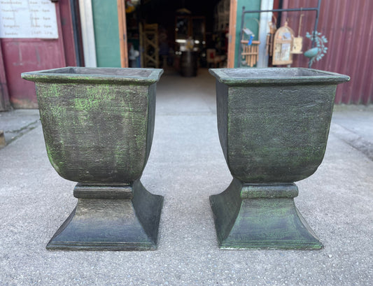 Matching pair of large outdoor urns in dark green colour