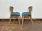 Set of 5 matching dining chairs in light wood with teal / light blue fabric