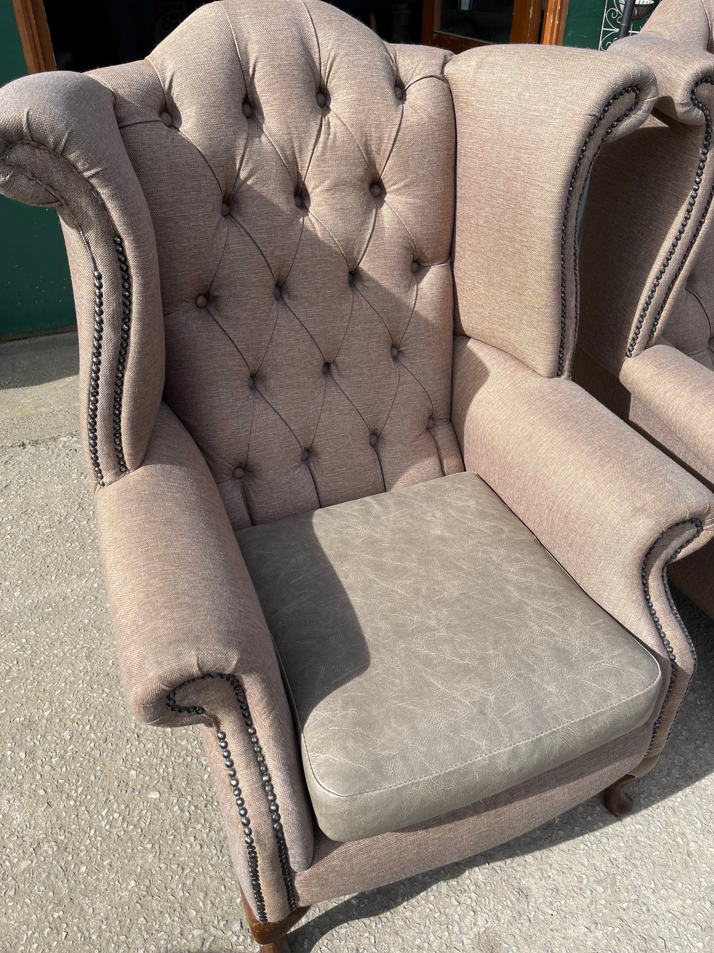 Pair of matching wingback armchairs in light brown / beige fabric