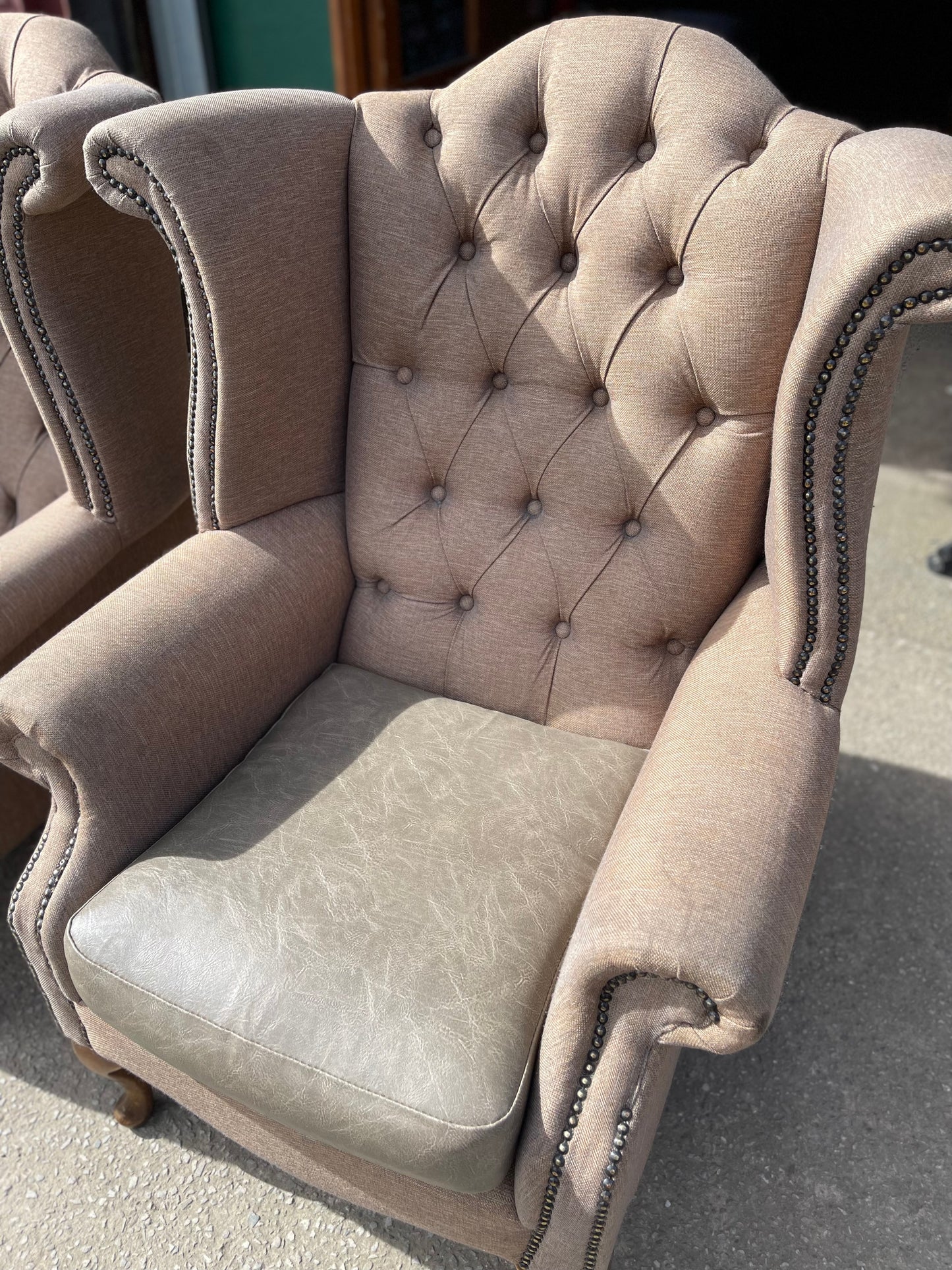 Pair of matching wingback armchairs in light brown / beige fabric