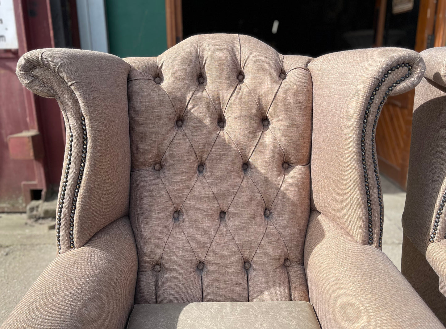 Pair of matching wingback armchairs in light brown / beige fabric