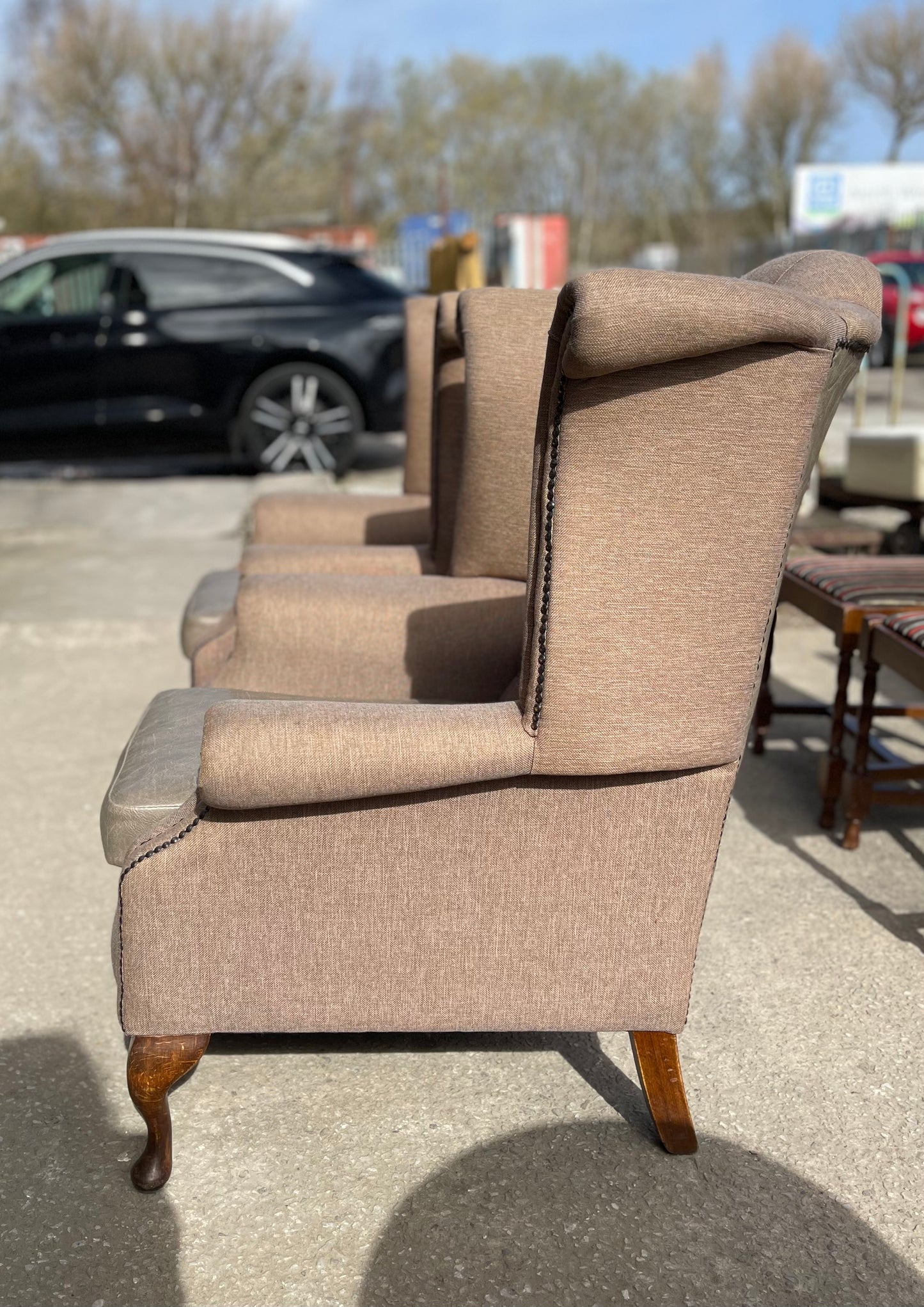 Pair of matching wingback armchairs in light brown / beige fabric
