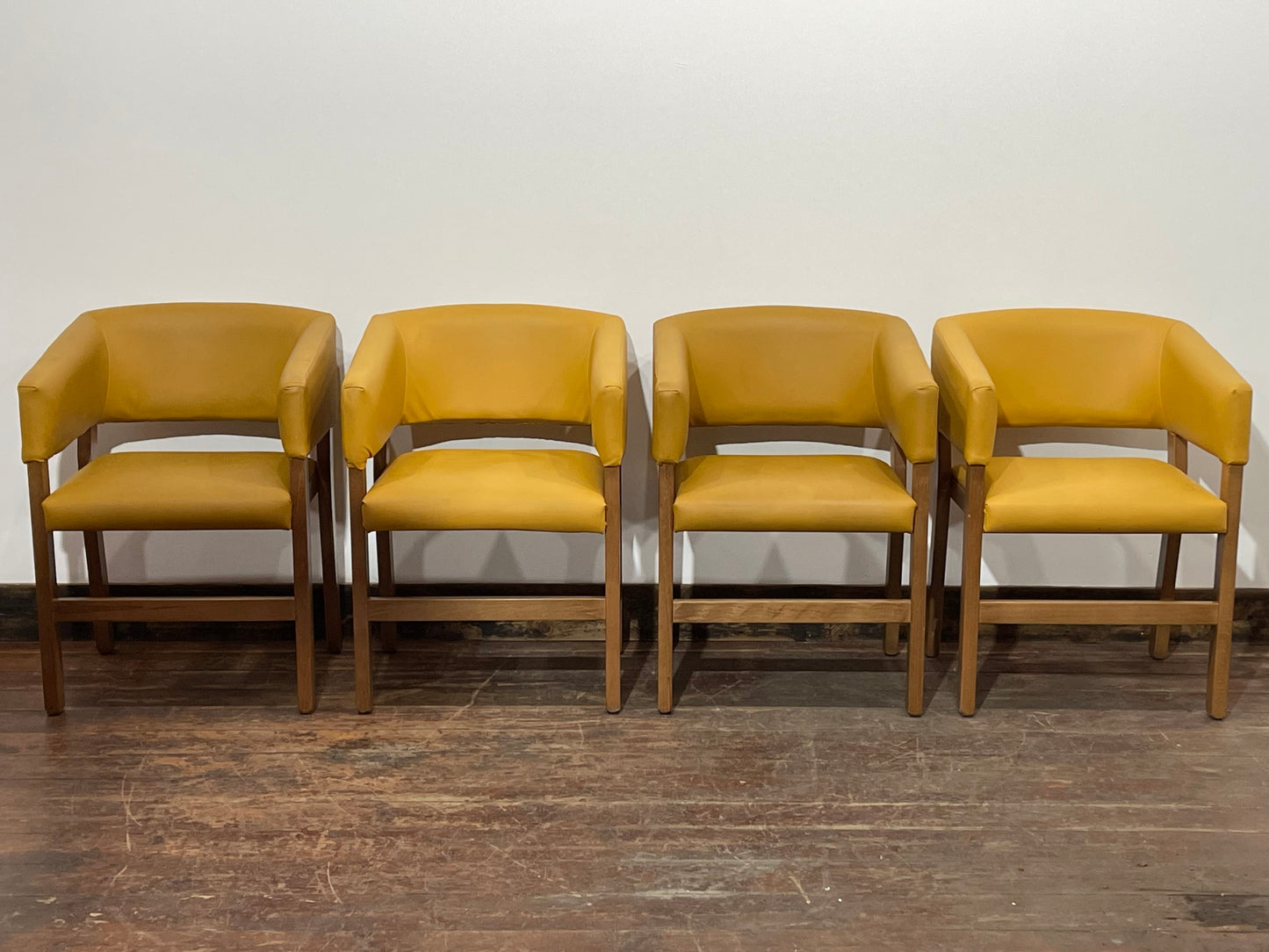 Matching set of 4 yellow tub chairs in faux-leather
