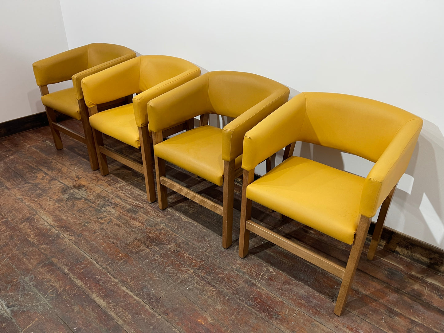 Matching set of 4 yellow tub chairs in faux-leather