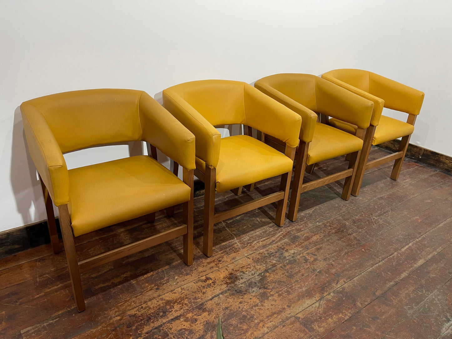 Matching set of 4 yellow tub chairs in faux-leather