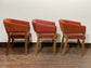 Matching set of 3 red - orange tub chairs in faux-leather