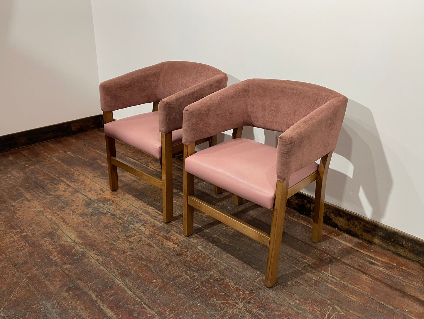 Matching set of 2 pale pink tub chairs in faux-leather
