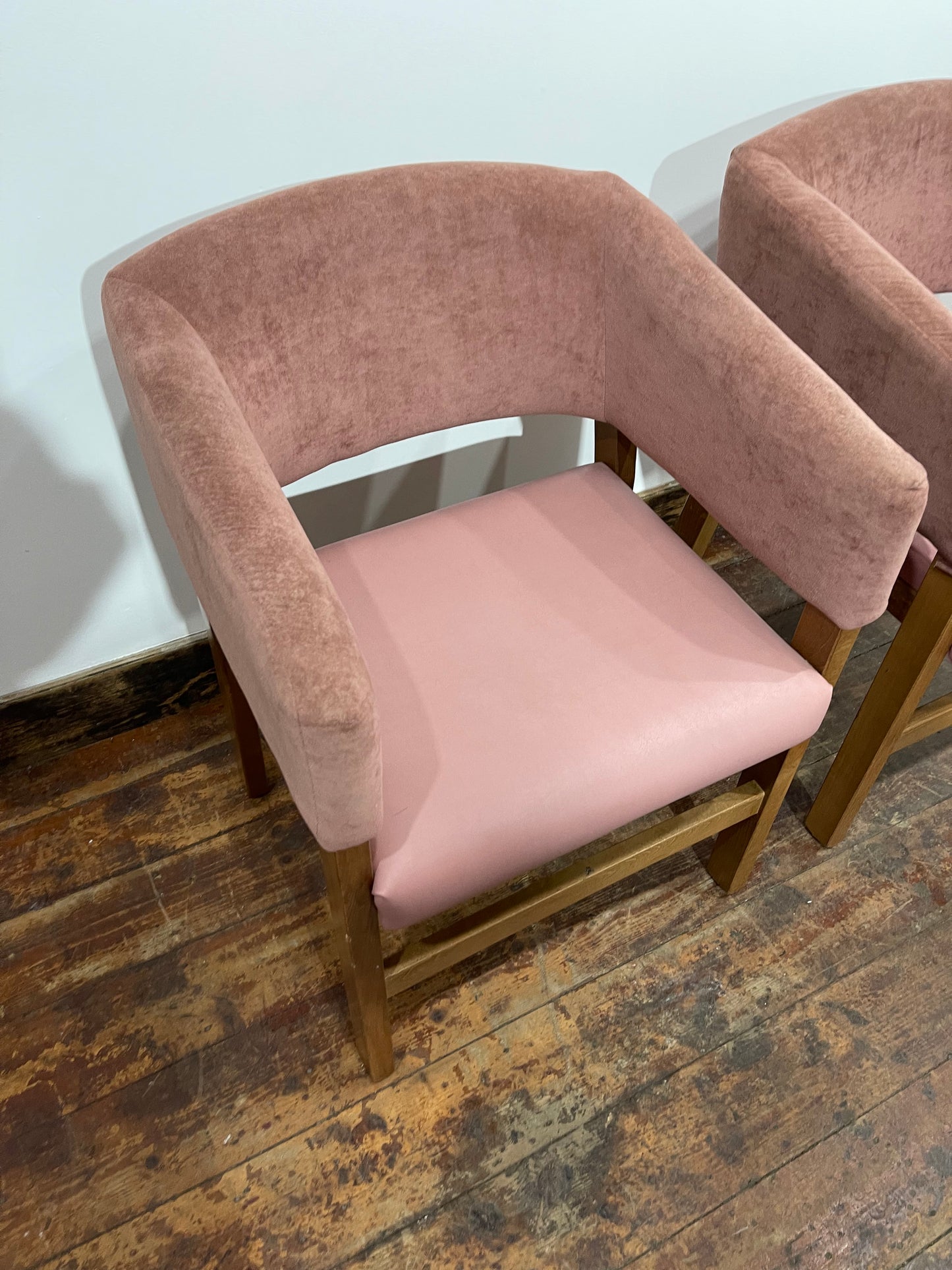 Matching set of 2 pale pink tub chairs in faux-leather