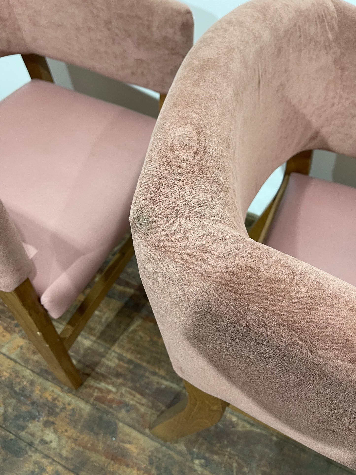 Matching set of 2 pale pink tub chairs in faux-leather