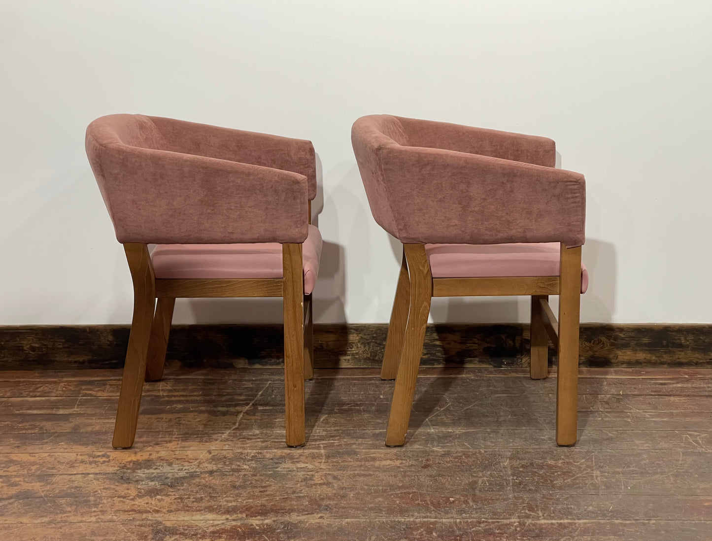 Matching set of 2 pale pink tub chairs in faux-leather