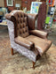 Brown leather wingback armchair with patterned fabric back and sides