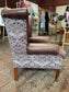 Brown leather wingback armchair with patterned fabric back and sides