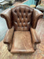 Brown leather wingback armchair with patterned fabric back and sides