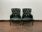 Pair of green leather armchairs with button backs