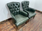 Pair of green leather armchairs with button backs