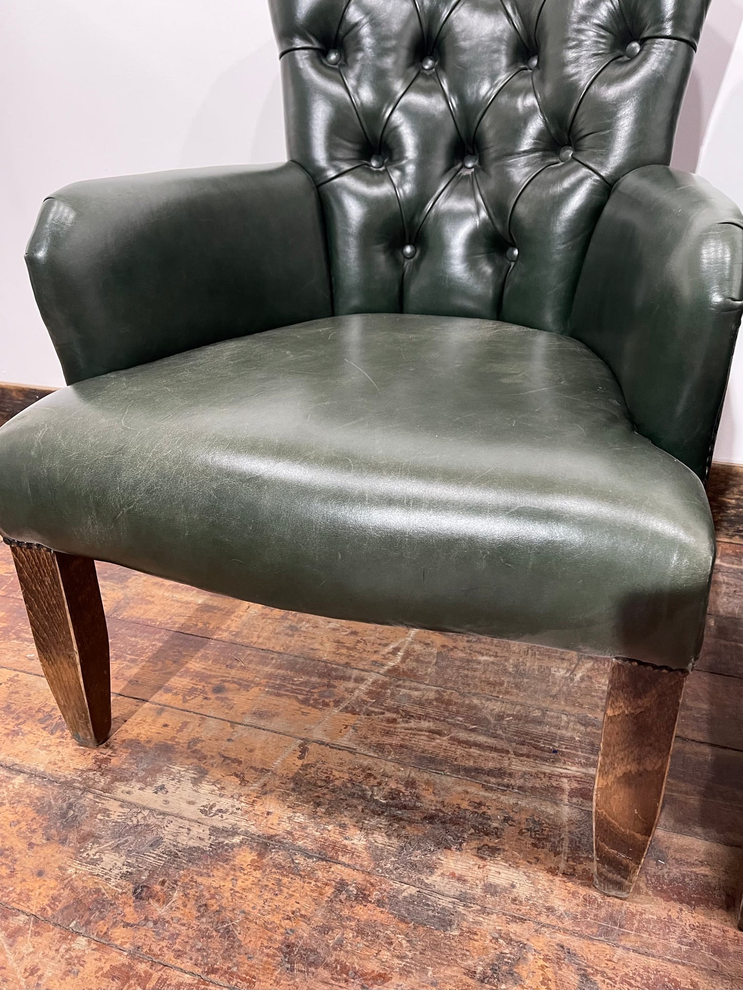 Pair of green leather armchairs with button backs