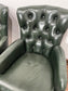Pair of green leather armchairs with button backs