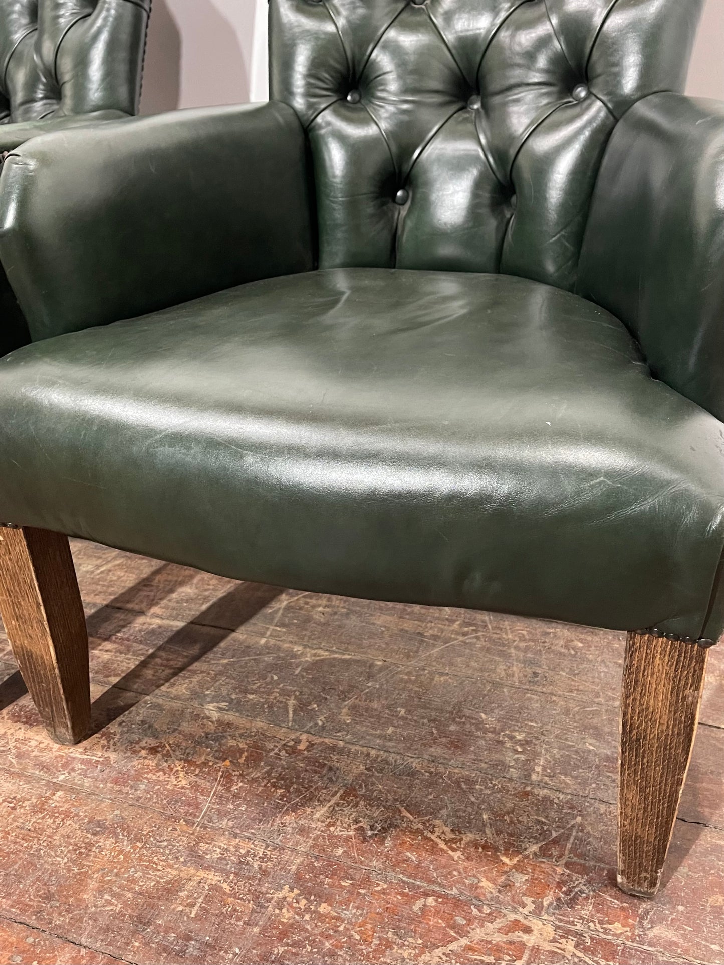 Pair of green leather armchairs with button backs